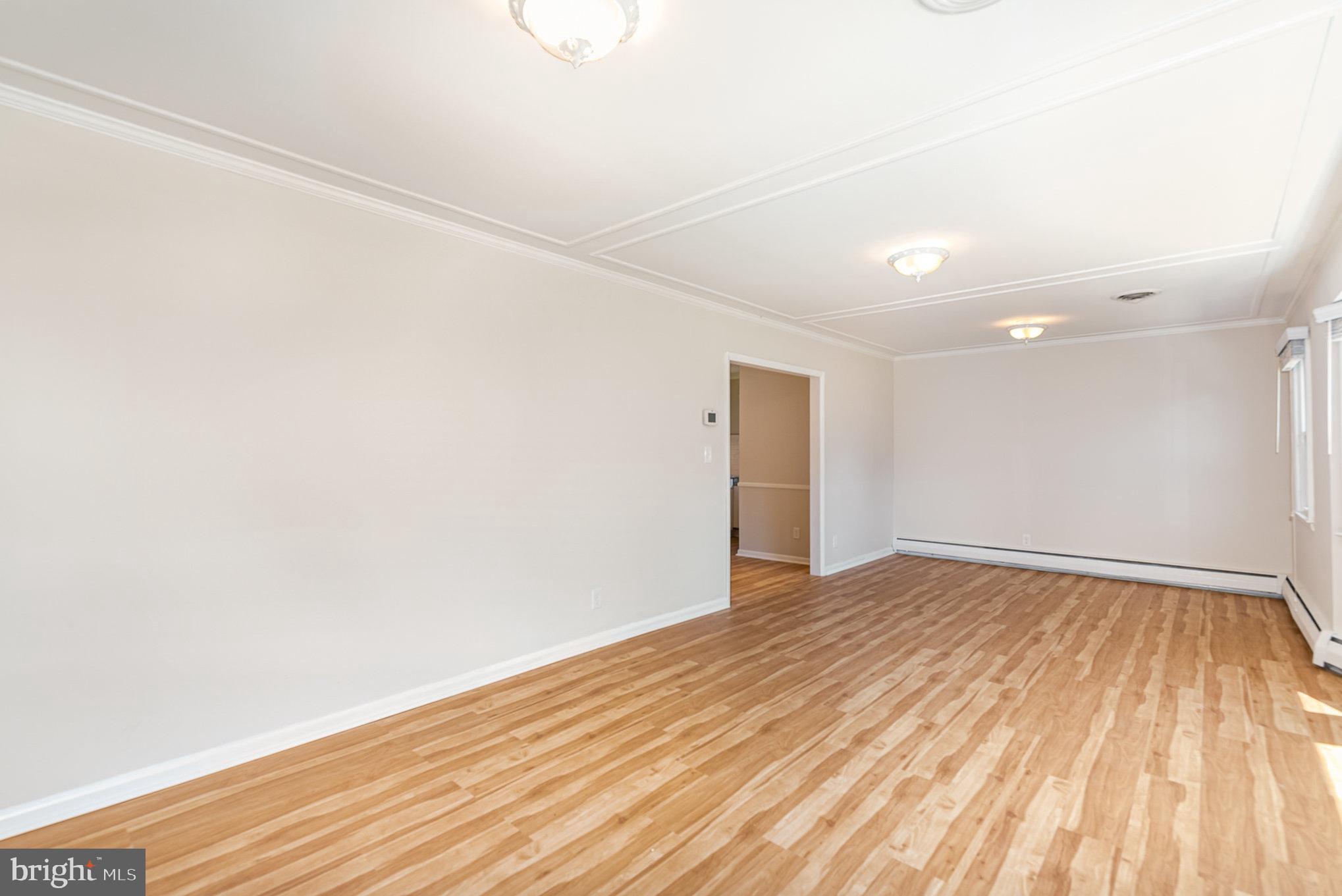 939 Starbit Road Towson, MD 21286 - Photo 32 of 52 a view of an empty room with wooden floor