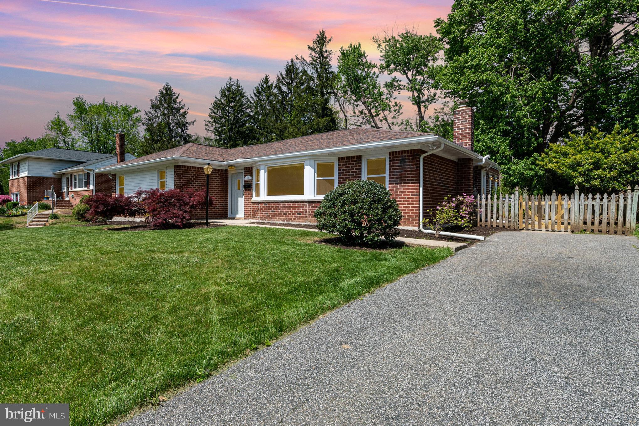 939 Starbit Road Towson, MD 21286 - Photo 35 of 52 a front view of a house with a garden and trees
