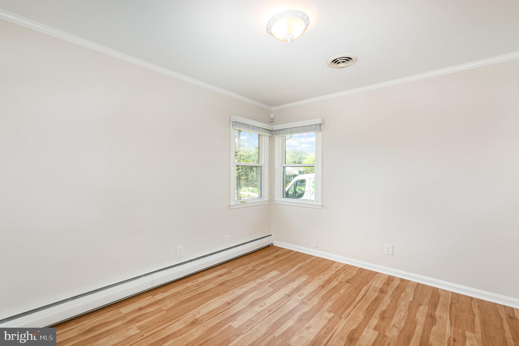 939 Starbit Road Towson, MD 21286 - Photo 38 of 52 an empty room with wooden floor and windows