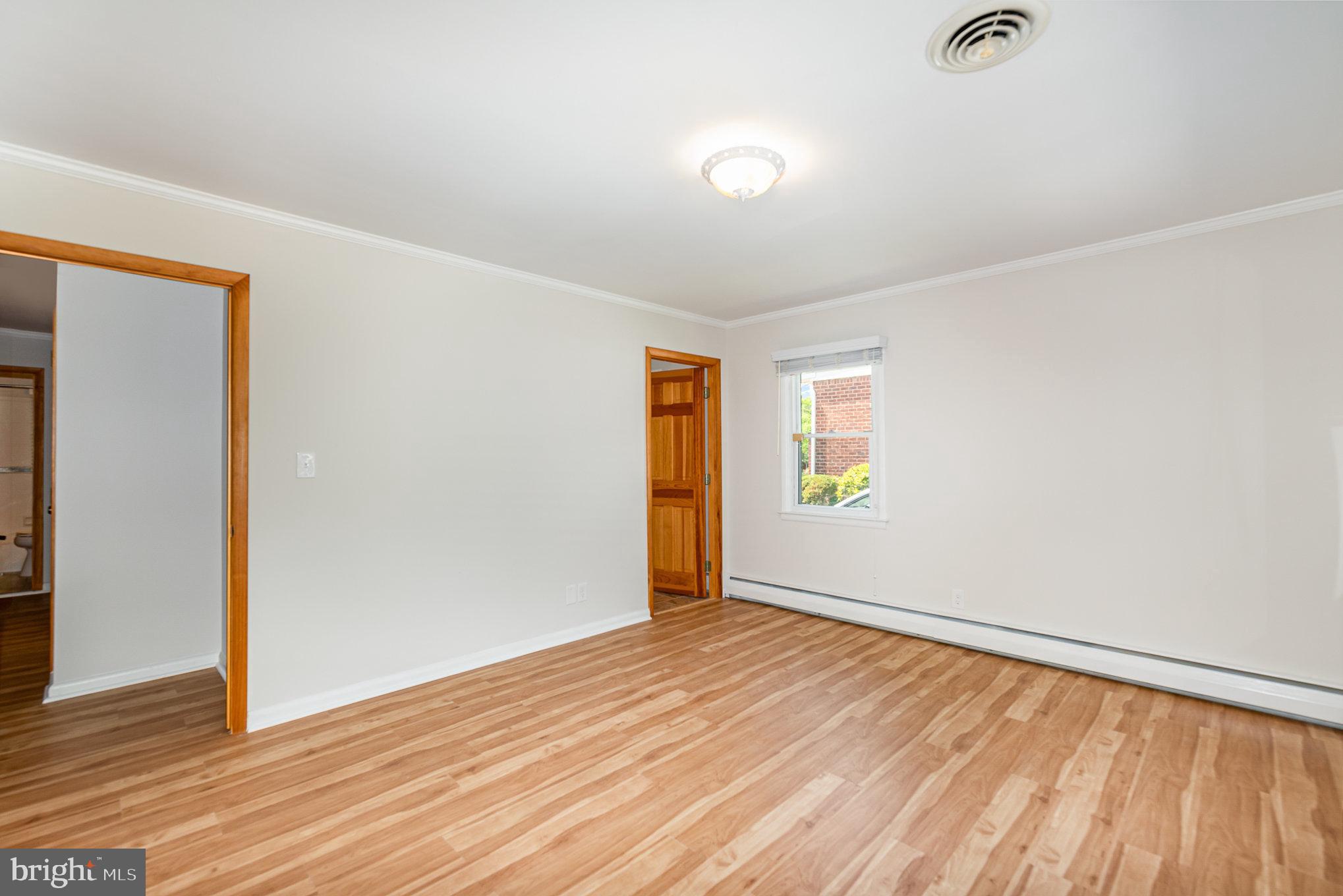 939 Starbit Road Towson, MD 21286 - Photo 39 of 52 an empty room with wooden floor and windows