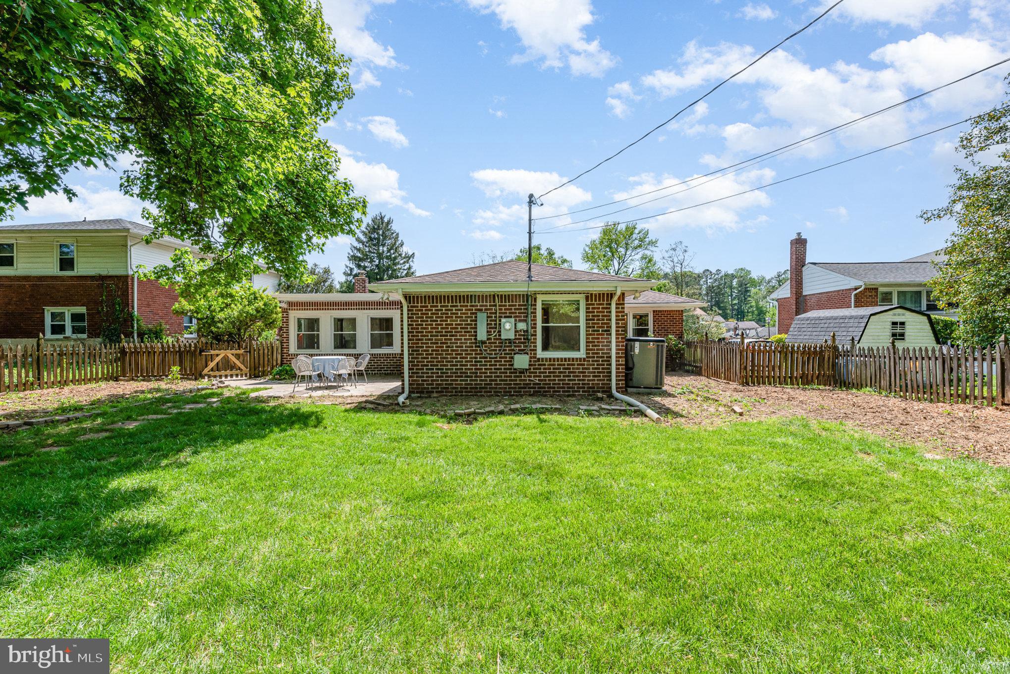 939 Starbit Road Towson, MD 21286 - Photo 42 of 52 a front view of a house with a garden