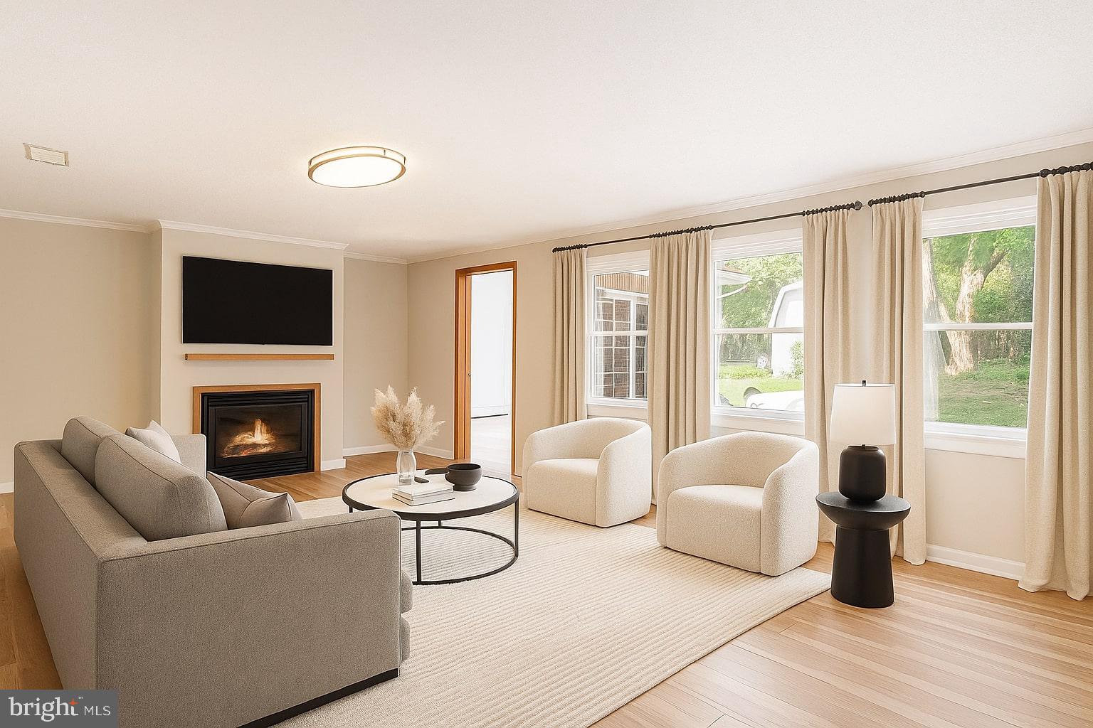 939 Starbit Road Towson, MD 21286 - Photo 51 of 52 a living room with furniture a fireplace and a large window