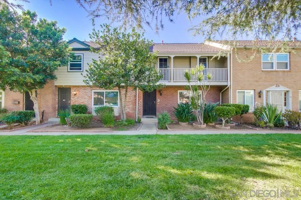 933 Greenfield Drive, Unit D El Cajon, CA 92021 - Photo 1 of 41 a front view of a house with a yard and trees