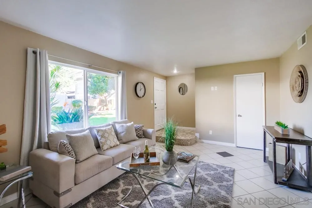 933 Greenfield Drive, Unit D El Cajon, CA 92021 - Photo 15 of 41 a living room with furniture and a large window