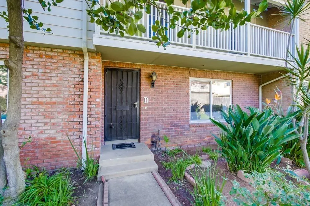 933 Greenfield Drive, Unit D El Cajon, CA 92021 - Photo 2 of 41 a front view of a house with a garden