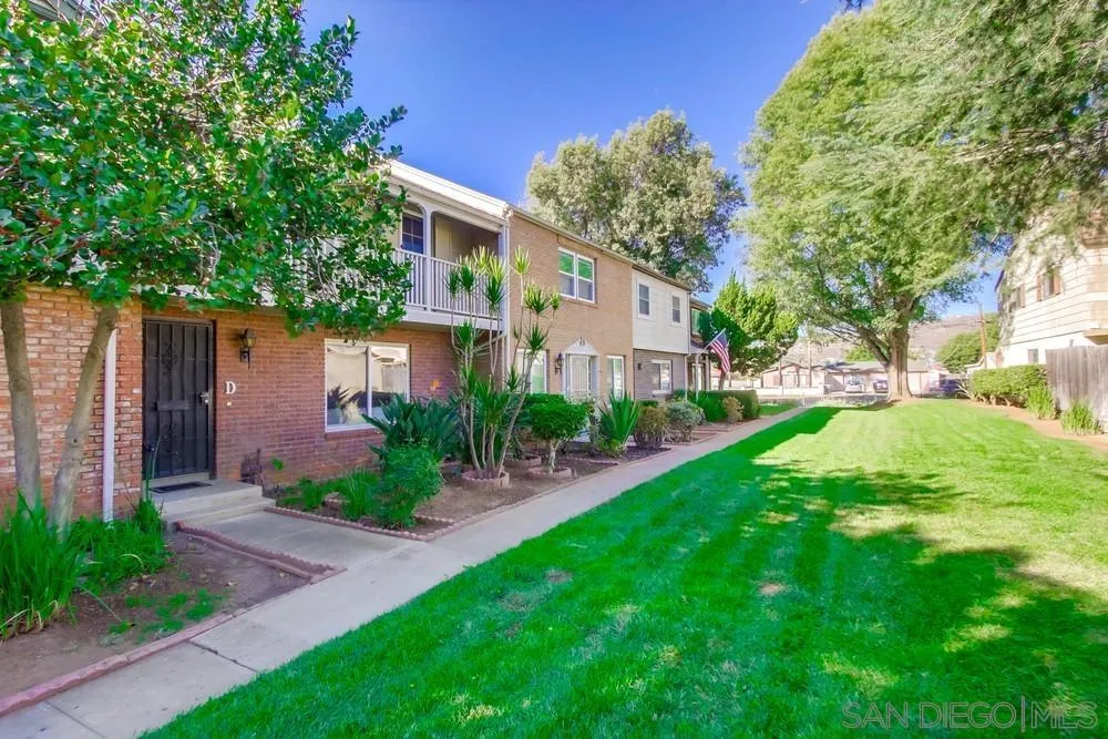 933 Greenfield Drive, Unit D El Cajon, CA 92021 - Photo 3 of 41 a front view of a house with a yard and potted plants