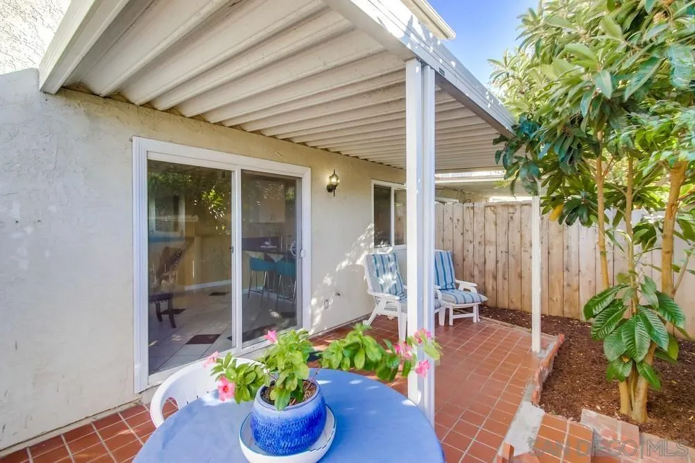 933 Greenfield Drive, Unit D El Cajon, CA 92021 - Photo 33 of 41 a front view of a house with a potted plant and floor to ceiling window