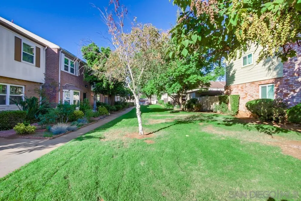 933 Greenfield Drive, Unit D El Cajon, CA 92021 - Photo 38 of 41 a view of a backyard with table and chairs and a small yard
