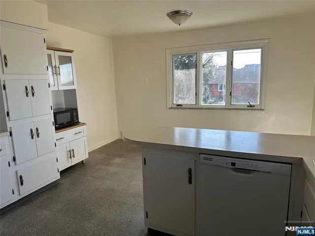 a kitchen with cabinets and window