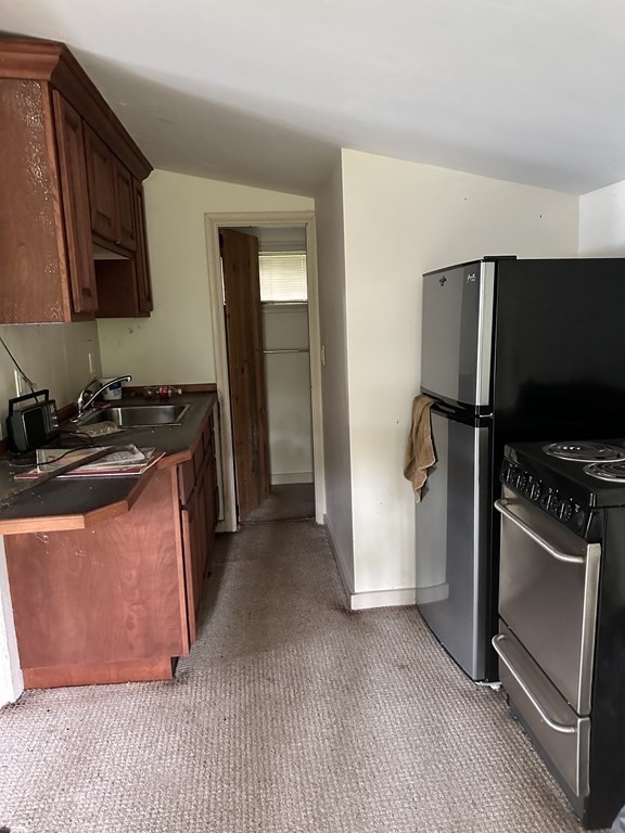 9 Washburn Terrace Spencer, MA 01562 - Photo 3 of 11 a kitchen with stainless steel appliances granite countertop a refrigerator stove and sink