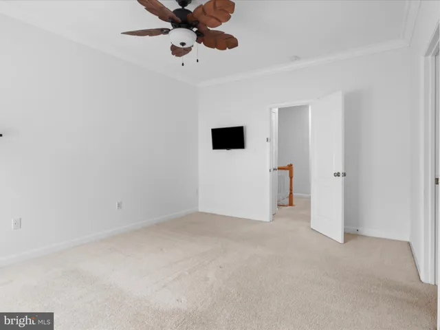 an empty room with closet and windows