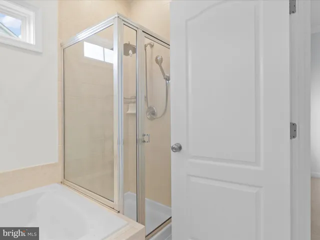 a bathroom with a glass shower door