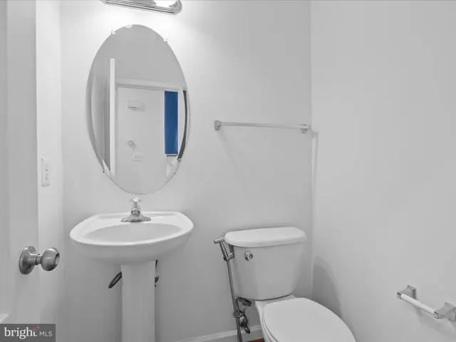 a bathroom with a toilet sink and mirror