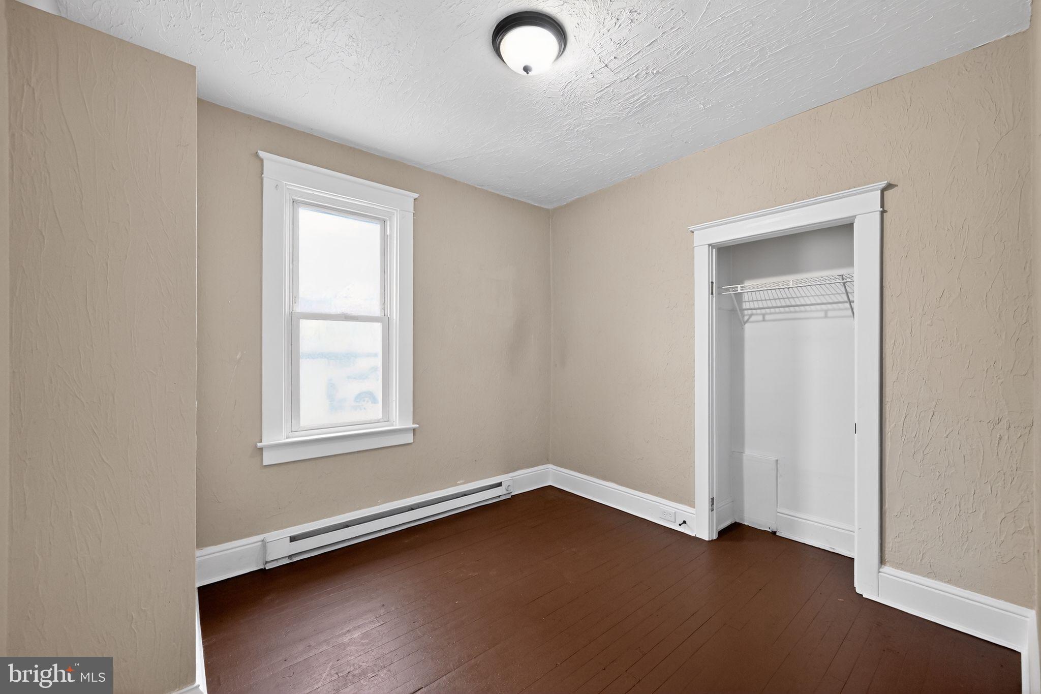 38 North Scott Street York, PA 17404 - Photo 3 of 16 an empty room with wooden floor and windows