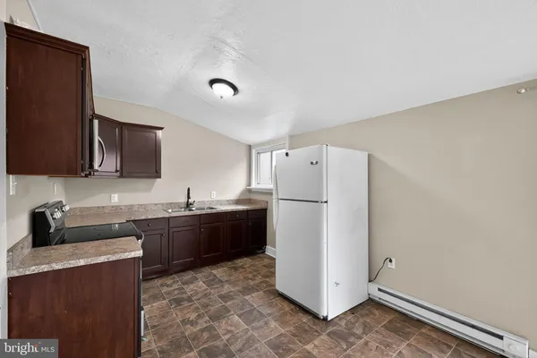 a kitchen with a refrigerator and a sink