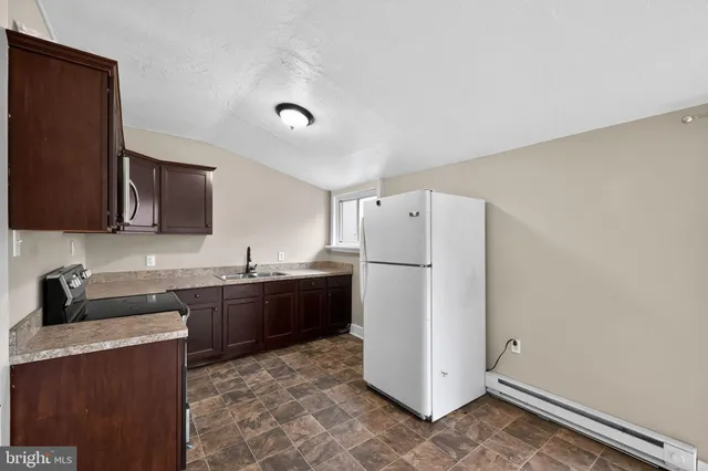 a kitchen with a refrigerator and a sink