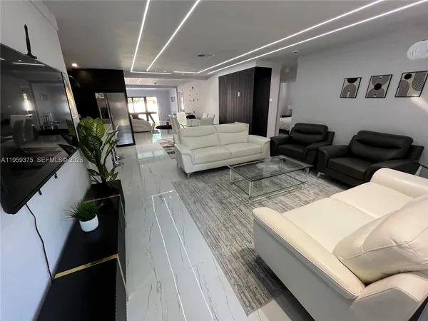 a living room with furniture and a flat screen tv