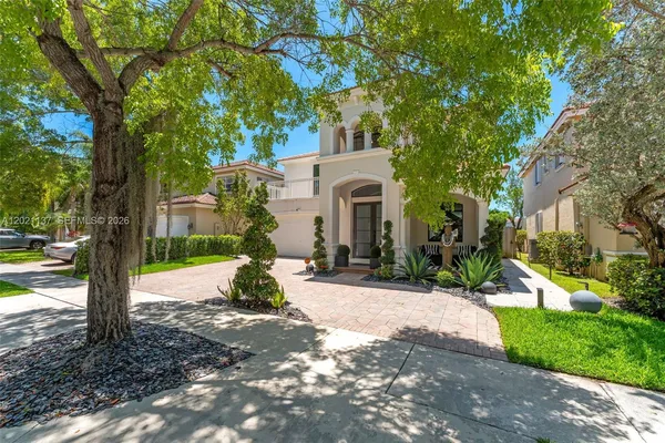 a view of a house with a tree in the background