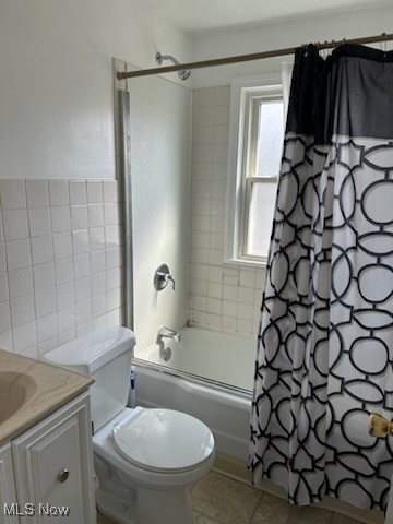11509 Granger Road Cleveland, OH 44125 - Photo 11 of 16 Bathroom featuring shower / bath combo, vanity, tile walls, and light tile patterned floors