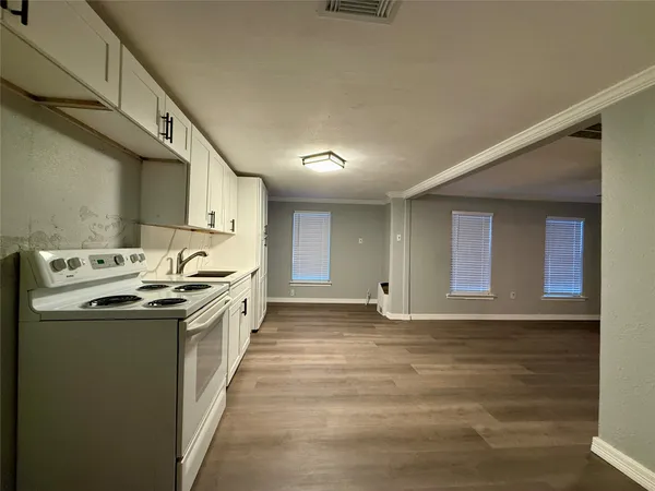 a kitchen with a sink stove and cabinets