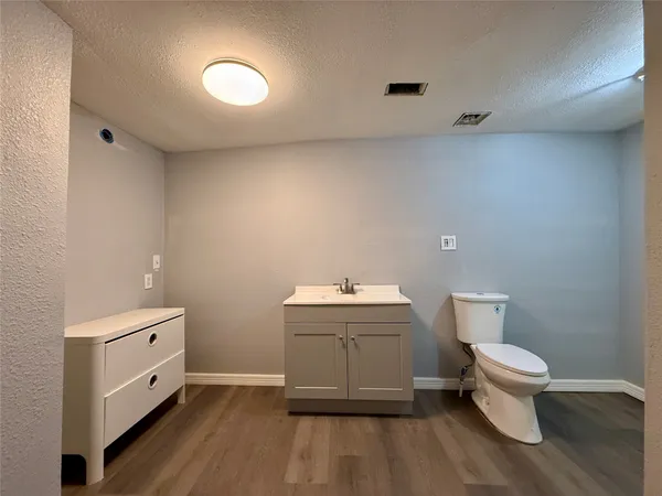 a spacious bathroom with a toilet and a sink