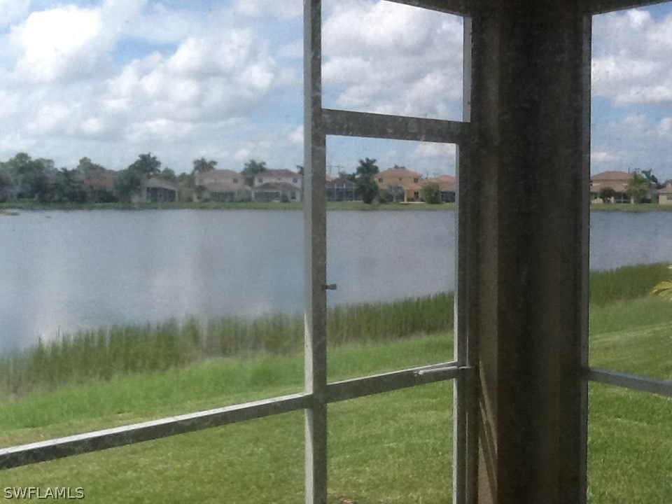 11672 Eros Road Lehigh Acres, FL 33971 - Photo 11 of 18 a view of a lake from a window