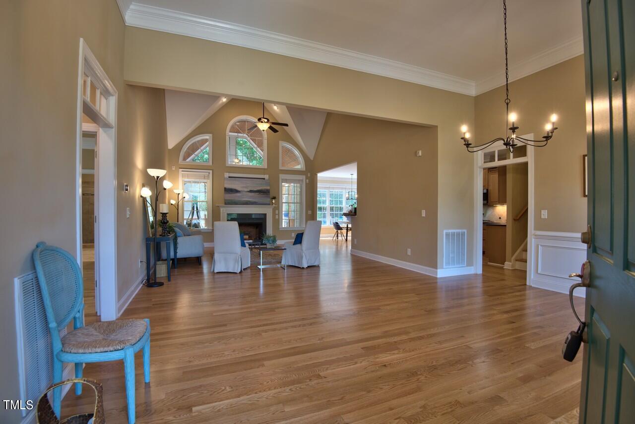 2919 Reynolda Circle Durham, NC 27712 - Photo 11 of 58 a view of a livingroom with furniture a fireplace wooden floor and staircase