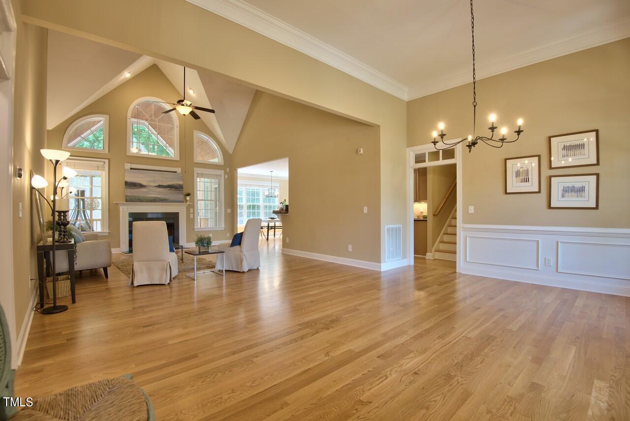 2919 Reynolda Circle Durham, NC 27712 - Photo 14 of 58 a view of a livingroom with furniture a fireplace wooden floor and chandelier