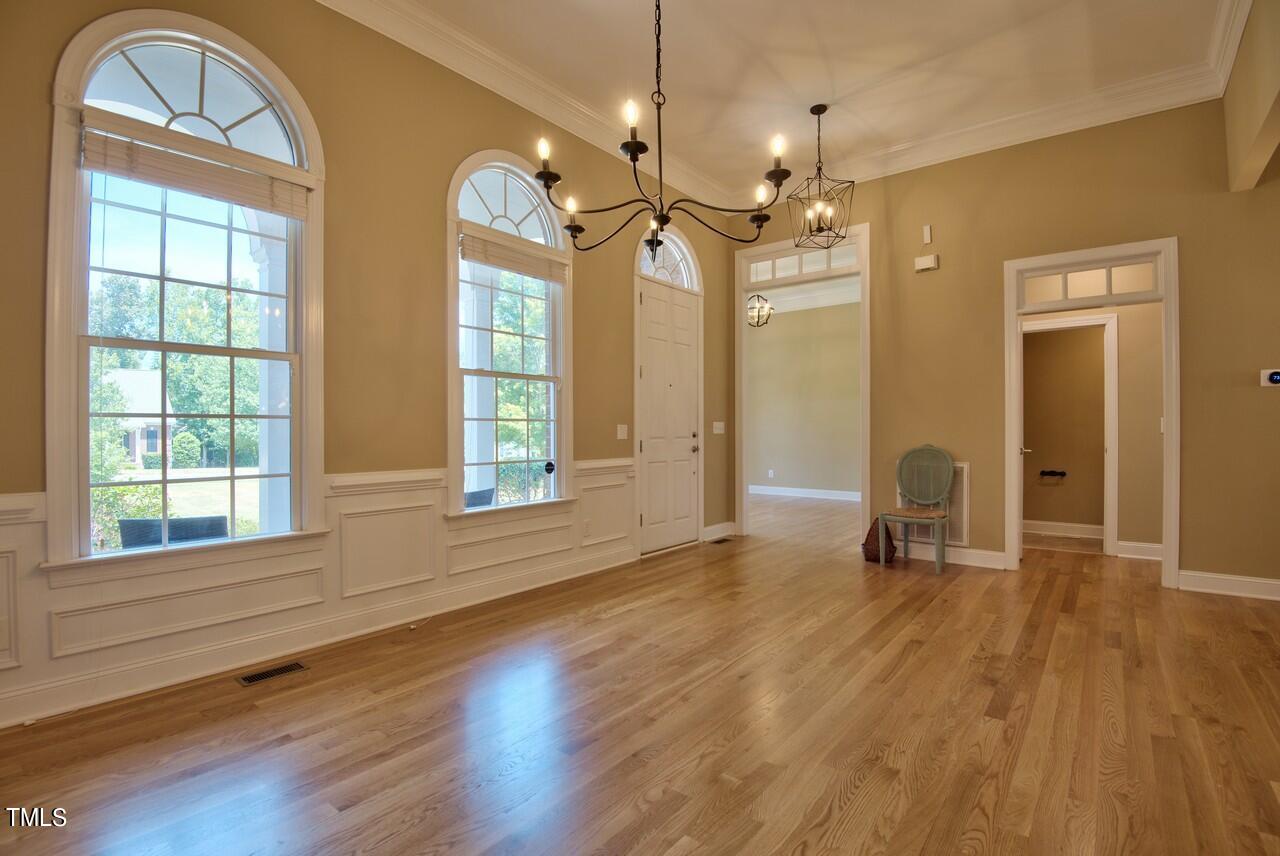 2919 Reynolda Circle Durham, NC 27712 - Photo 16 of 58 a view of a livingroom with a large window wooden floor and a chandelier