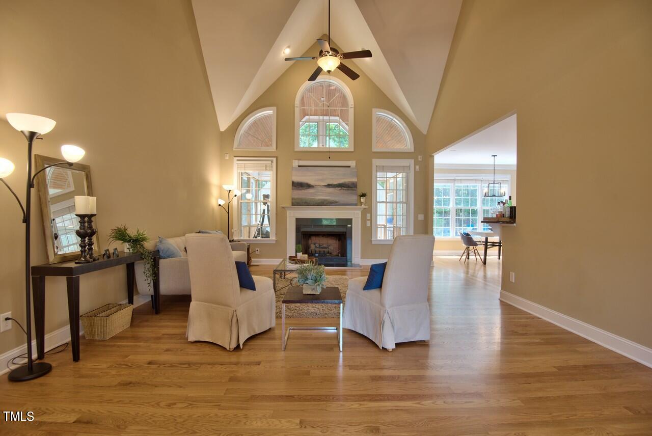 2919 Reynolda Circle Durham, NC 27712 - Photo 18 of 58 a living room with furniture a fireplace and a chandelier