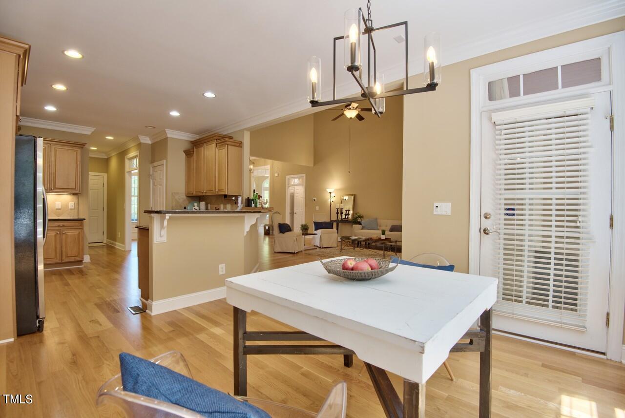 2919 Reynolda Circle Durham, NC 27712 - Photo 25 of 58 a view of a dining room and livingroom with furniture wooden floor a chandelier