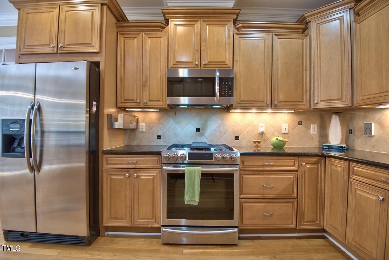2919 Reynolda Circle Durham, NC 27712 - Photo 28 of 58 a kitchen with stainless steel appliances granite countertop a refrigerator stove and sink