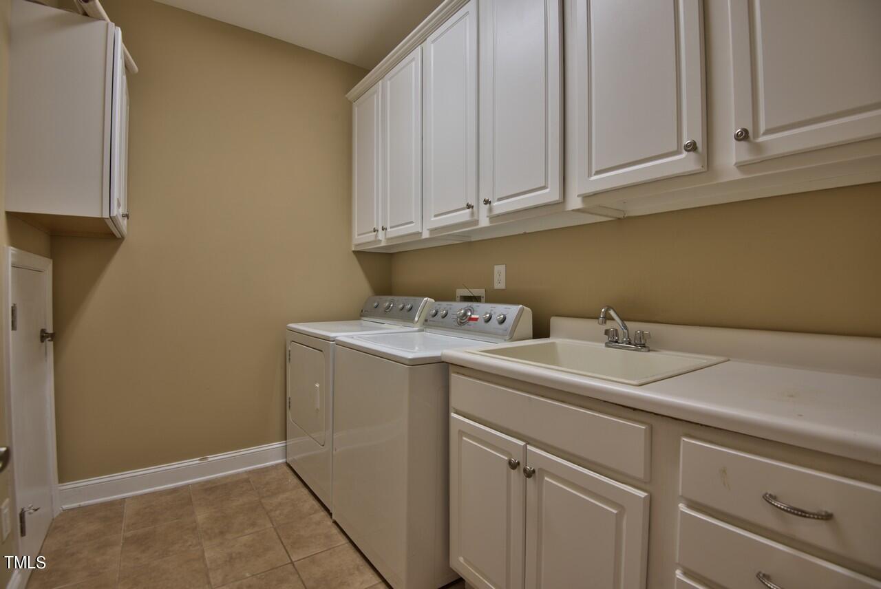 2919 Reynolda Circle Durham, NC 27712 - Photo 31 of 58 a utility room with sink dryer and washer