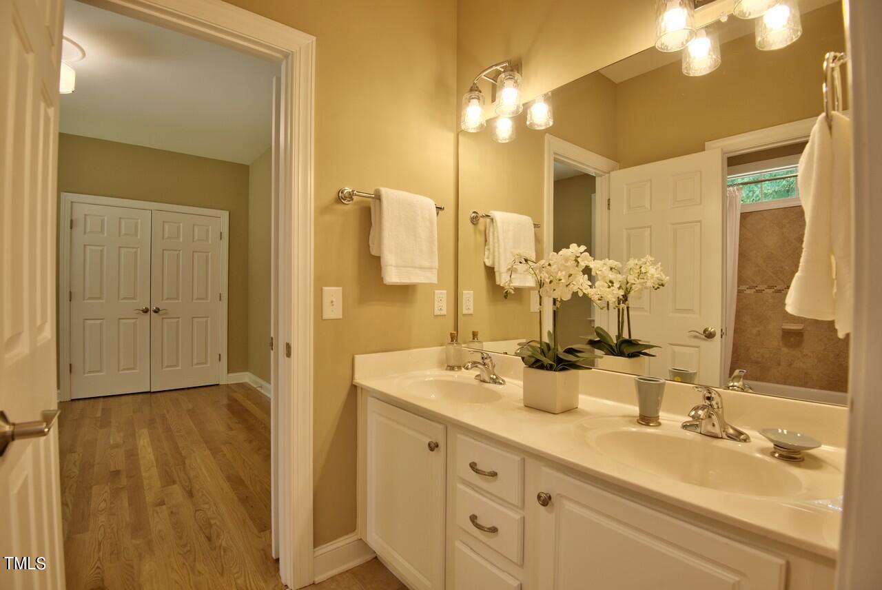 2919 Reynolda Circle Durham, NC 27712 - Photo 33 of 58 a bathroom with a double vanity sink and a mirror