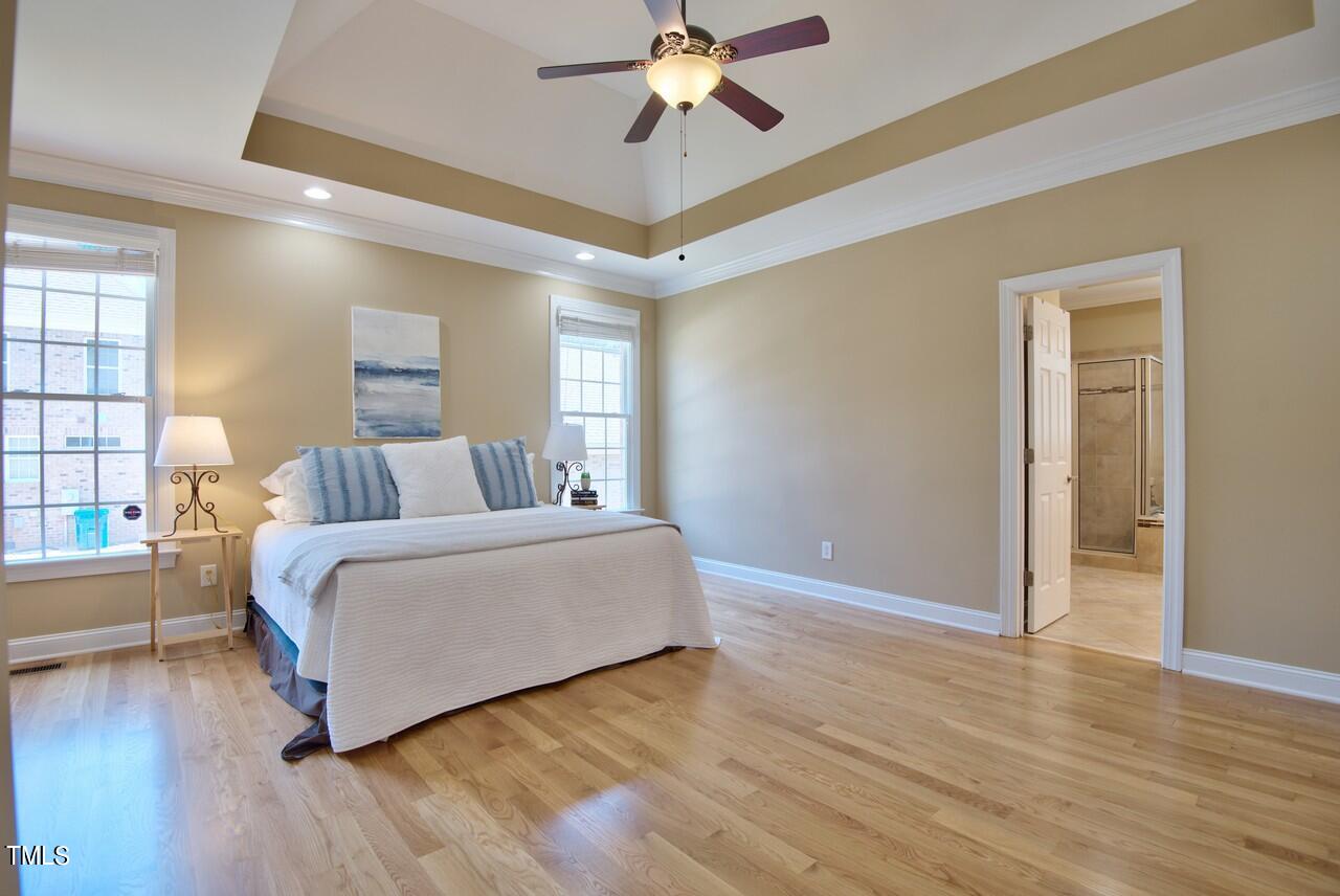 2919 Reynolda Circle Durham, NC 27712 - Photo 38 of 58 a spacious bedroom with a bed and a chandelier
