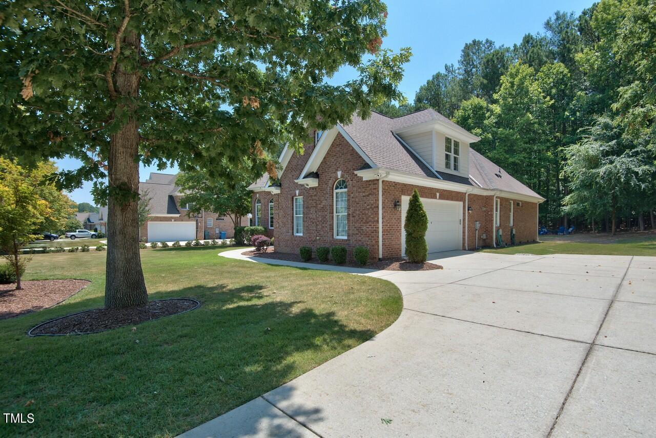 2919 Reynolda Circle Durham, NC 27712 - Photo 10 of 58 a front view of a house with a garden and tree