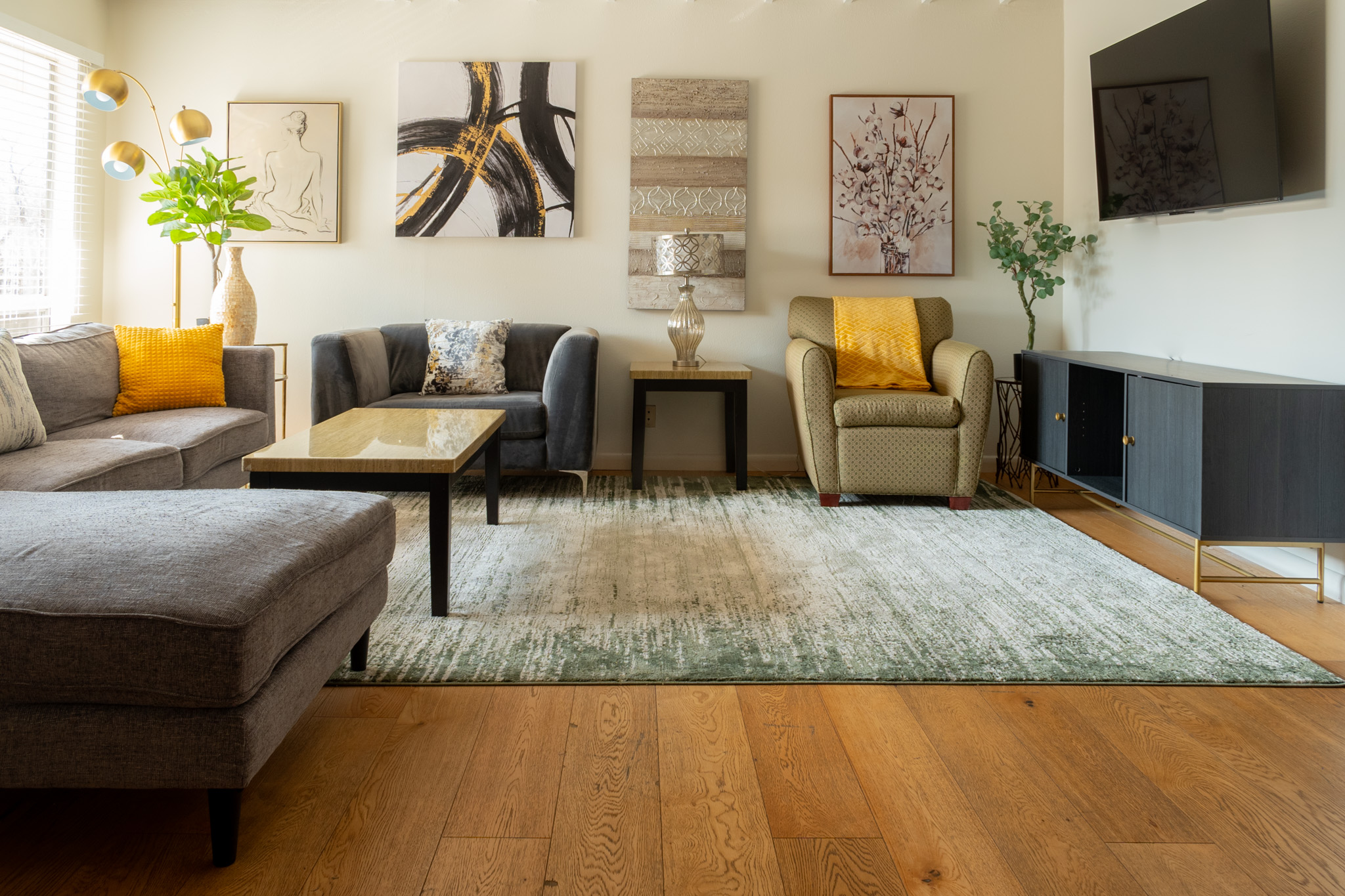 500 East Riverside Drive, Unit 224 Austin, TX 78704 - Photo 2 of 19 A well-lit living area showcases inviting seating arrangements and rich hardwood flooring, perfect for comfortable gatherings.