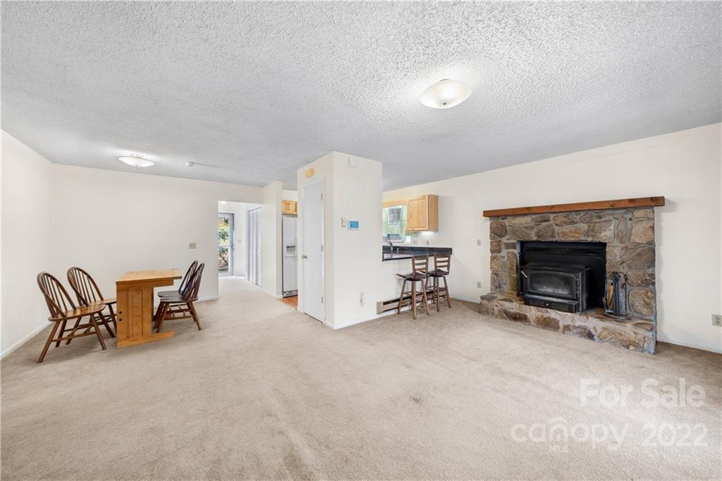 4 Blue Jay Loop Maggie Valley, NC 28751 - Photo 11 of 46 an empty room with furniture and a fireplace