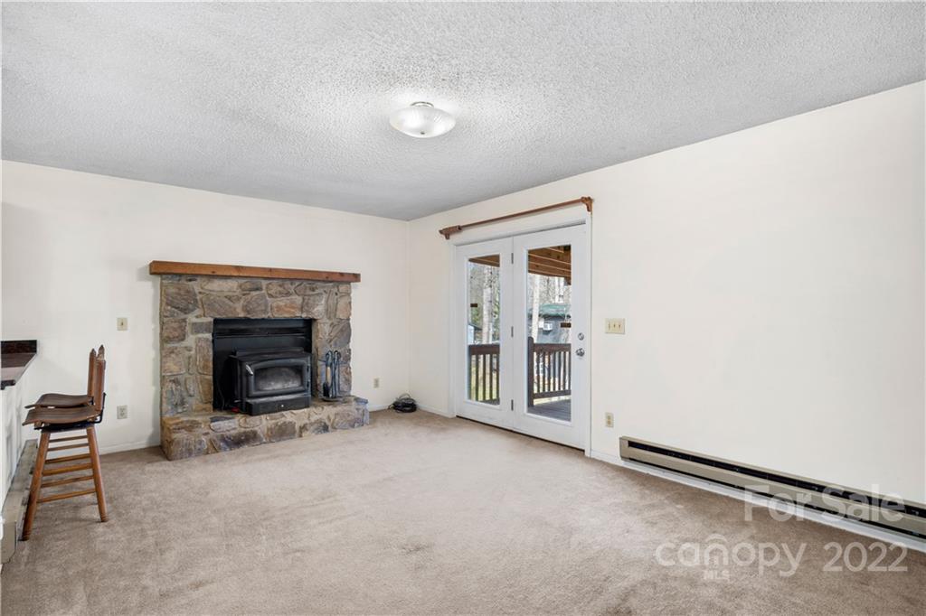 4 Blue Jay Loop Maggie Valley, NC 28751 - Photo 13 of 46 an empty room with furniture and a fireplace