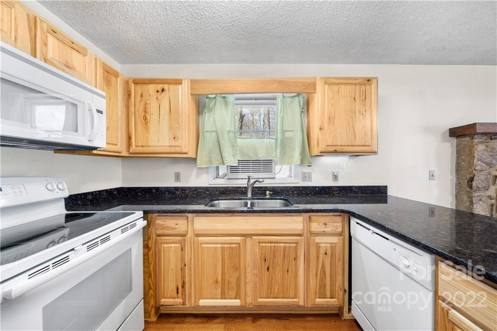 4 Blue Jay Loop Maggie Valley, NC 28751 - Photo 2 of 46 a kitchen with granite countertop a sink and a stove