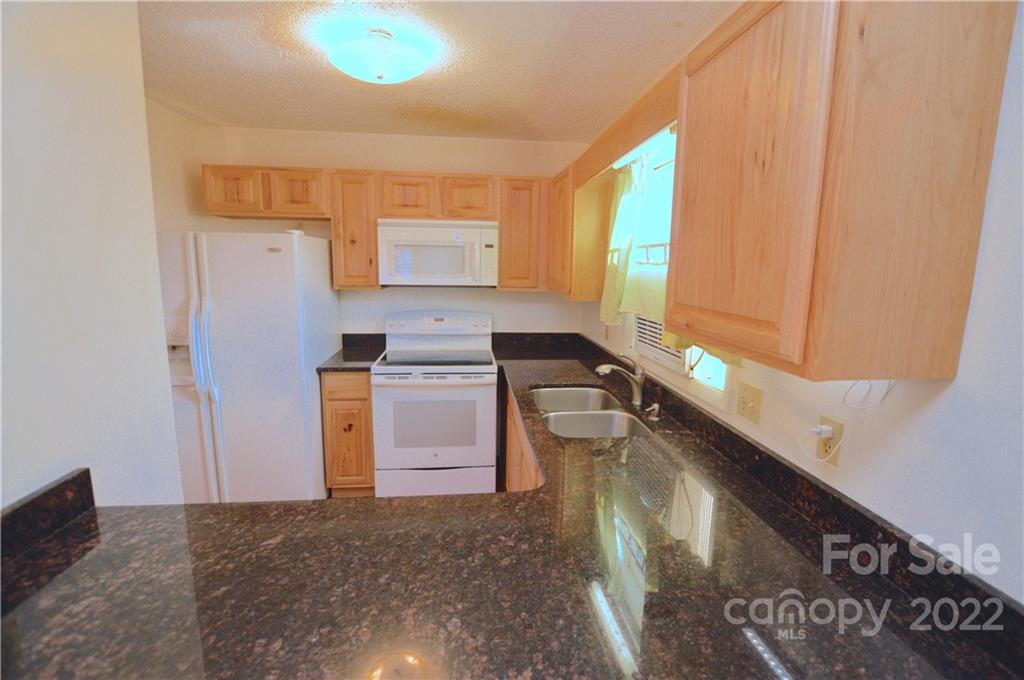 4 Blue Jay Loop Maggie Valley, NC 28751 - Photo 35 of 46 a kitchen with a sink cabinets and a stove
