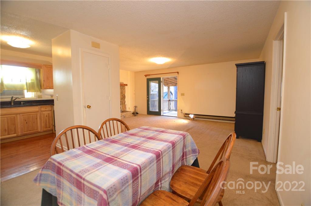 4 Blue Jay Loop Maggie Valley, NC 28751 - Photo 37 of 46 a bedroom with a bed and a table with mirror