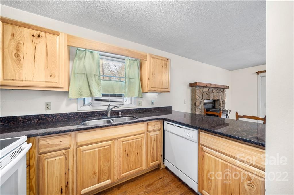 4 Blue Jay Loop Maggie Valley, NC 28751 - Photo 8 of 46 a kitchen with granite countertop cabinets sink and large window