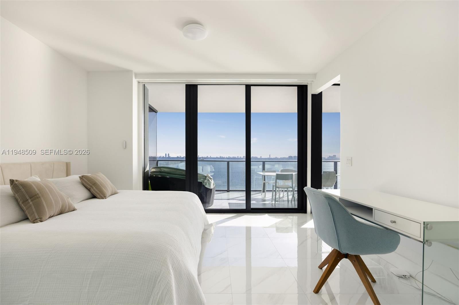 3131 Northeast 7th Avenue, Unit 1902 Miami, FL 33137 - Photo 11 of 15 a spacious bedroom with a large window and a bed