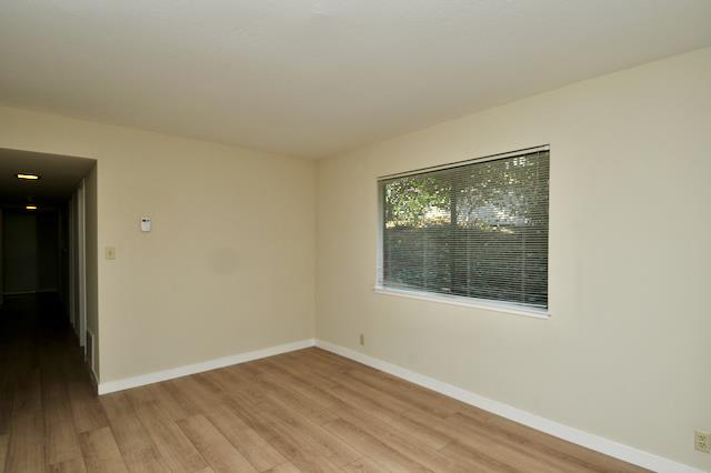 Undisclosed Address Millbrae, CA 94030 - Photo 12 of 30 an empty room with wooden floor and windows