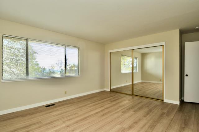 Undisclosed Address Millbrae, CA 94030 - Photo 27 of 30 a view of an empty room with wooden floor and a window