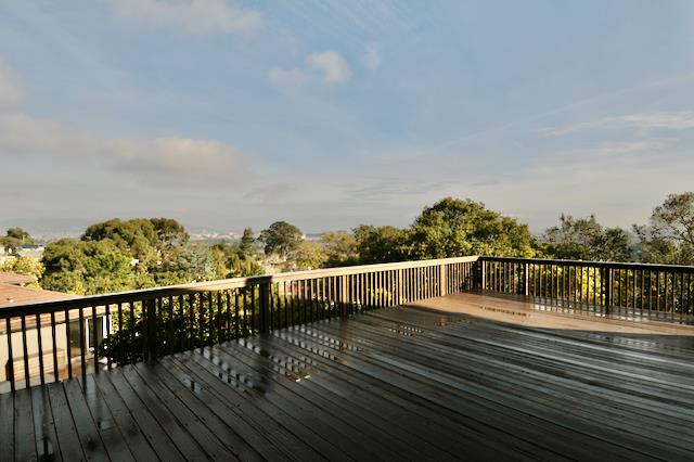 Undisclosed Address Millbrae, CA 94030 - Photo 29 of 30 a view of a balcony with wooden floor next to a yard