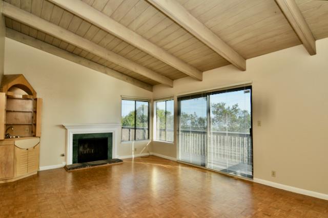 Undisclosed Address Millbrae, CA 94030 - Photo 6 of 30 an empty room with wooden floor and fireplace