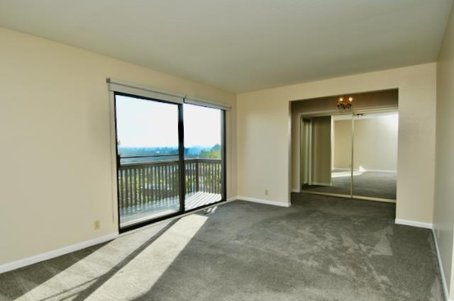 Undisclosed Address Millbrae, CA 94030 - Photo 9 of 30 an empty room with sliding door and mountain view