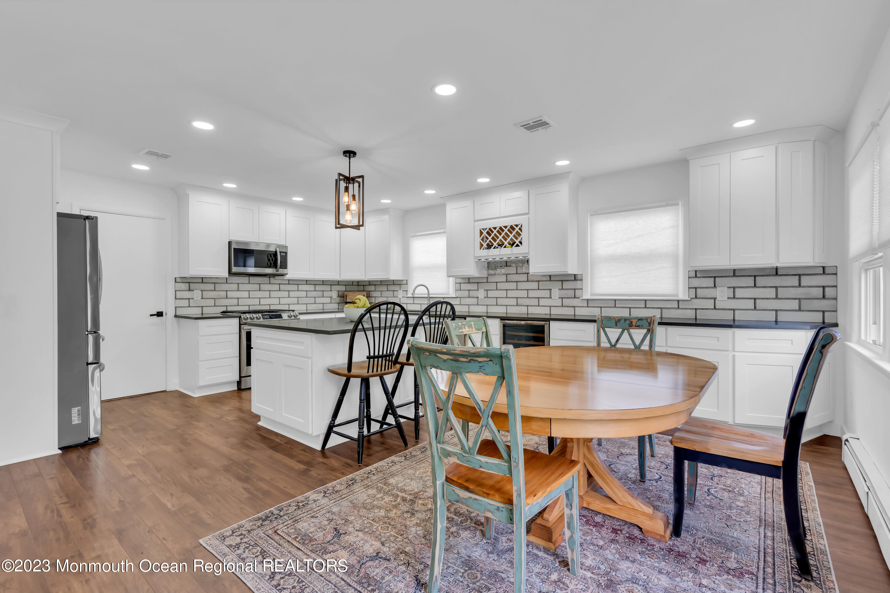 11 Garrett Road Toms River, NJ 08757 - Photo 27 of 61 a kitchen with stainless steel appliances granite countertop a table chairs sink refrigerator and microwave
